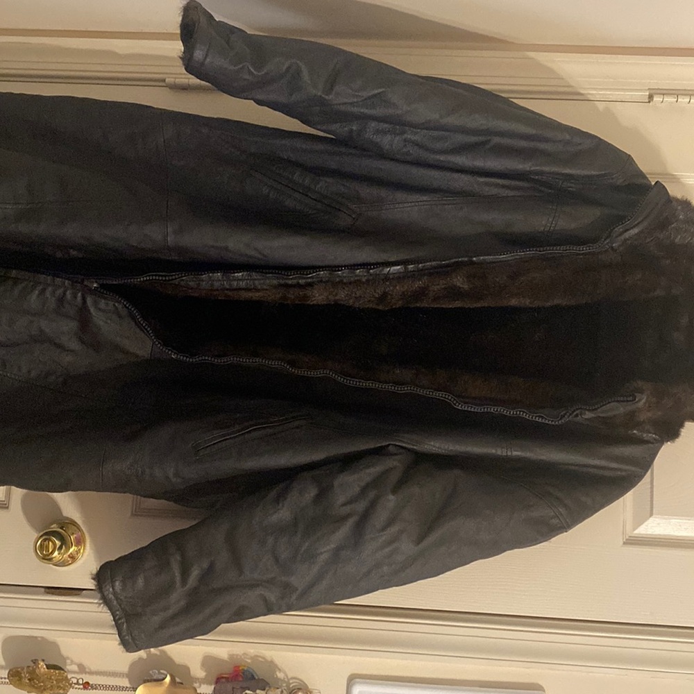 Brown leather and faux fur reversible coat with pockets.